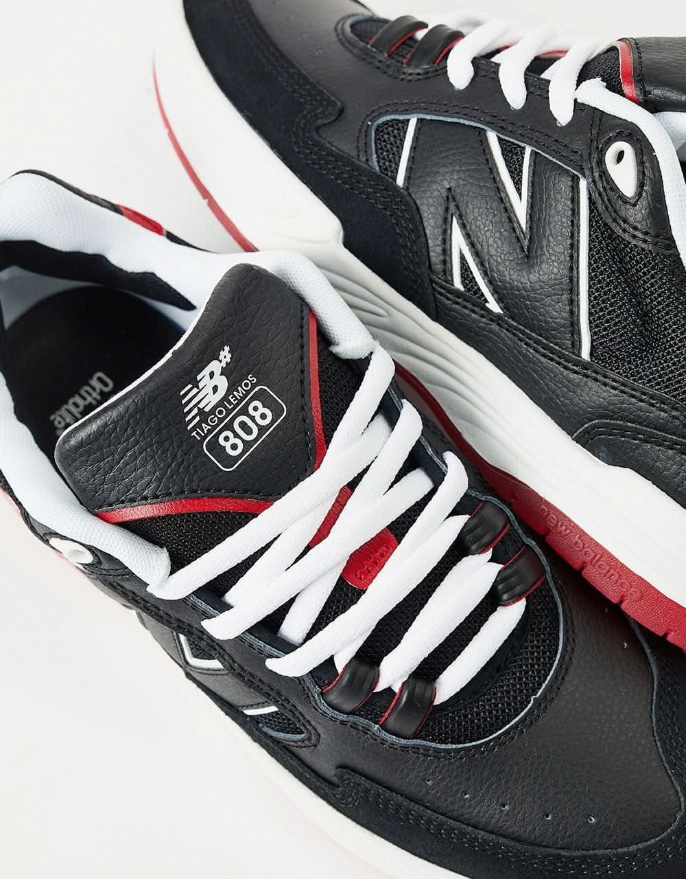 Red and black sales new balance shoes